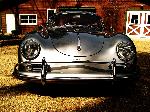 Coupe in front of barn